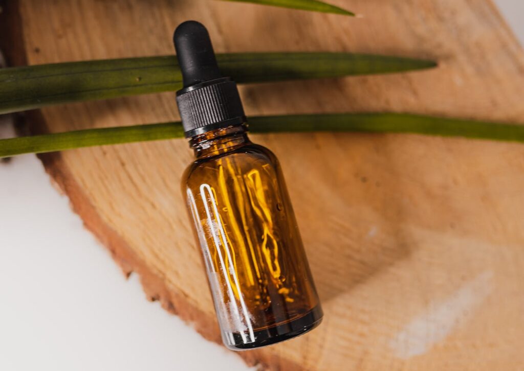 small essential oil bottle on decorative tree trunk