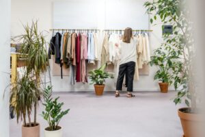 woman fixing clothes on the rack