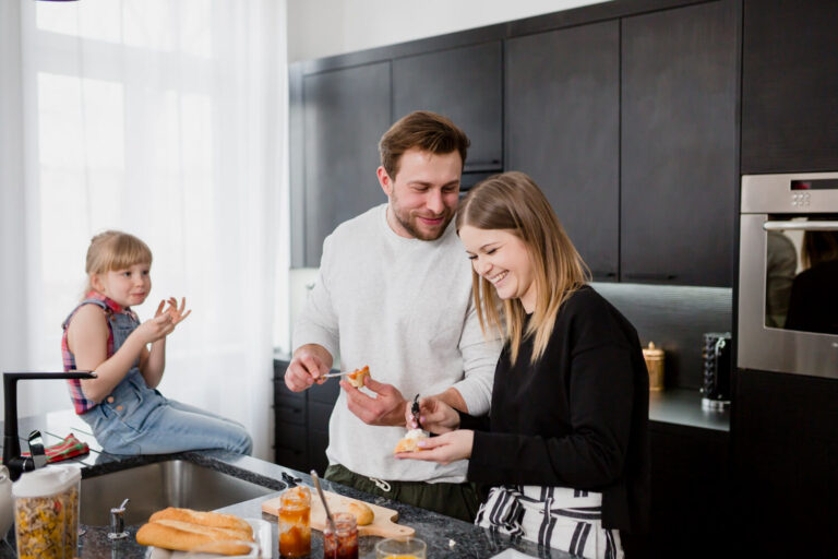 couple making sandwiches near daughter