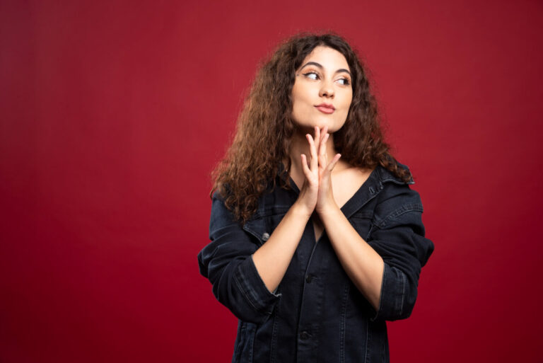 curly woman looking her side with her hands closed