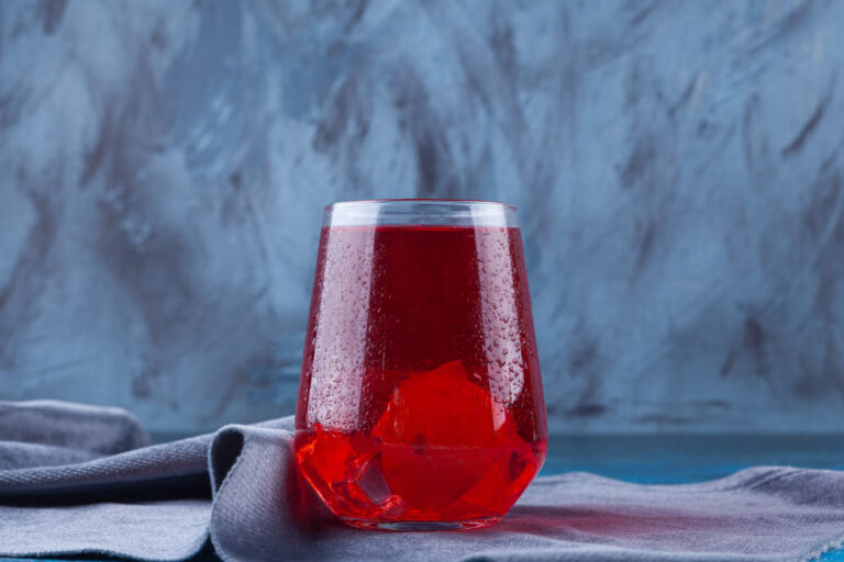 glass cup fruit juice placed tablecloth