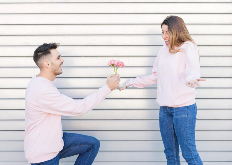 guy with flowers near surprised lady