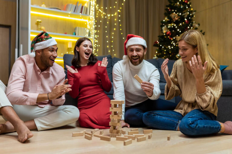 new year party various friends home floor playing game men women smiling happy