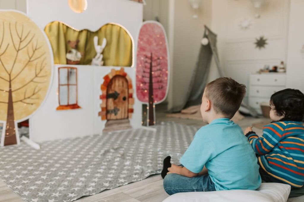 two boys watching a puppet show