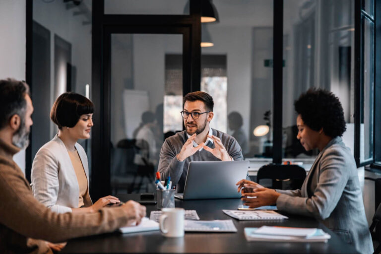 senior manager is sitting boardroom with multiracial colleagues discussing project