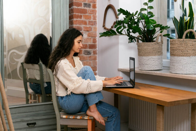 side view woman working laptop home