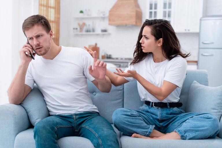 woman being angry while her boyfriend is talking phone