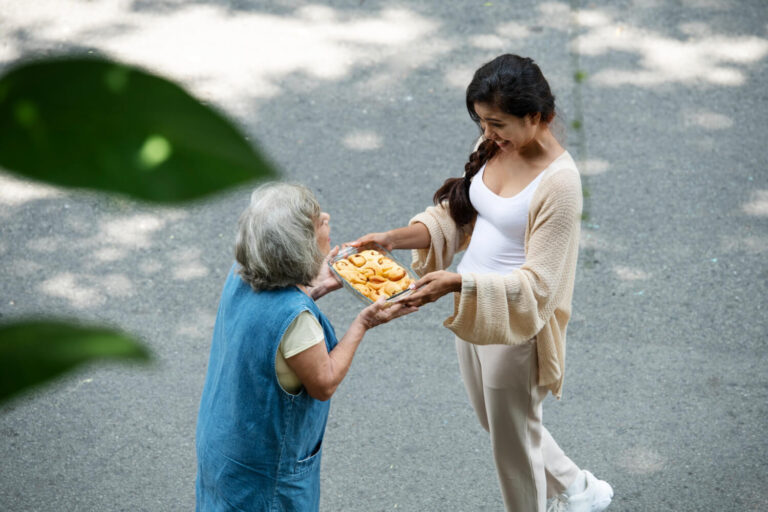 woman offering food neighbor