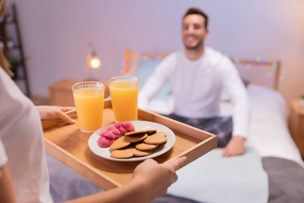romantic girl brings breakfast her husband