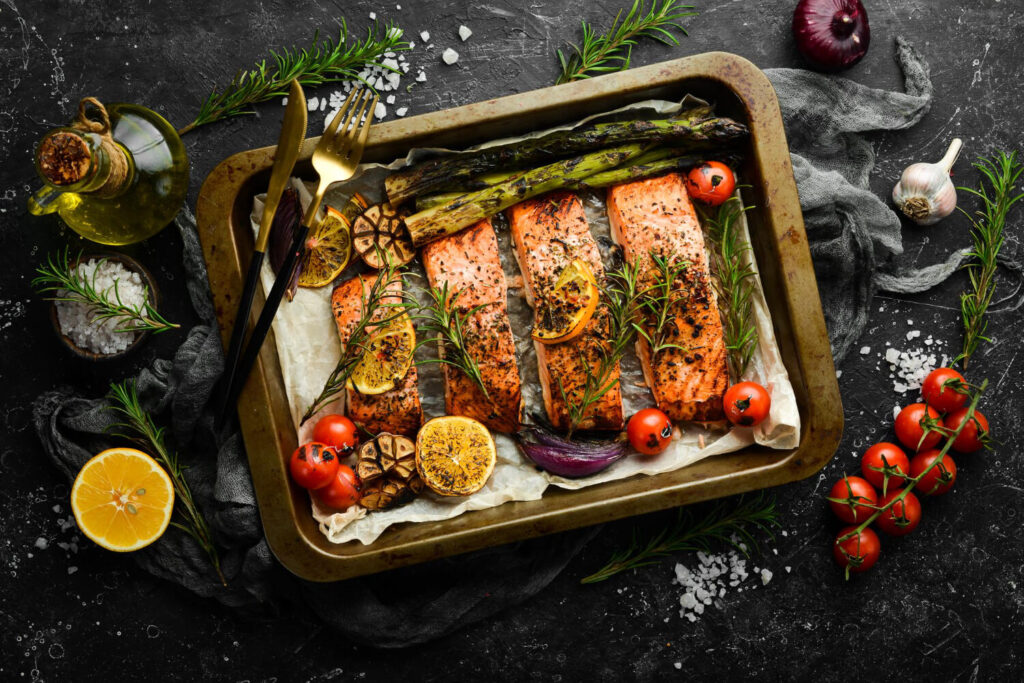 salmon baked metal tray with vegetables rosemary recipe seafood free space text