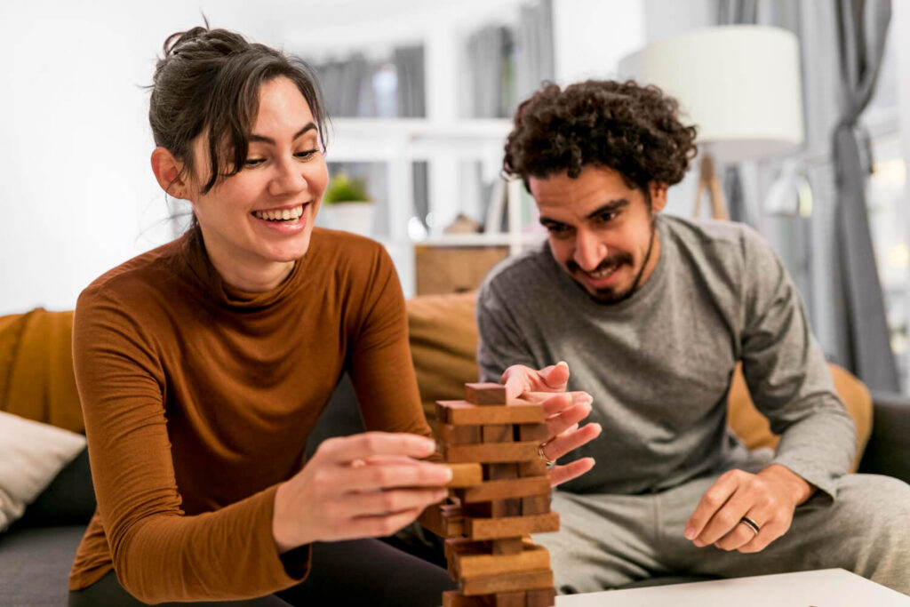 wife husband playing wooden tower game
