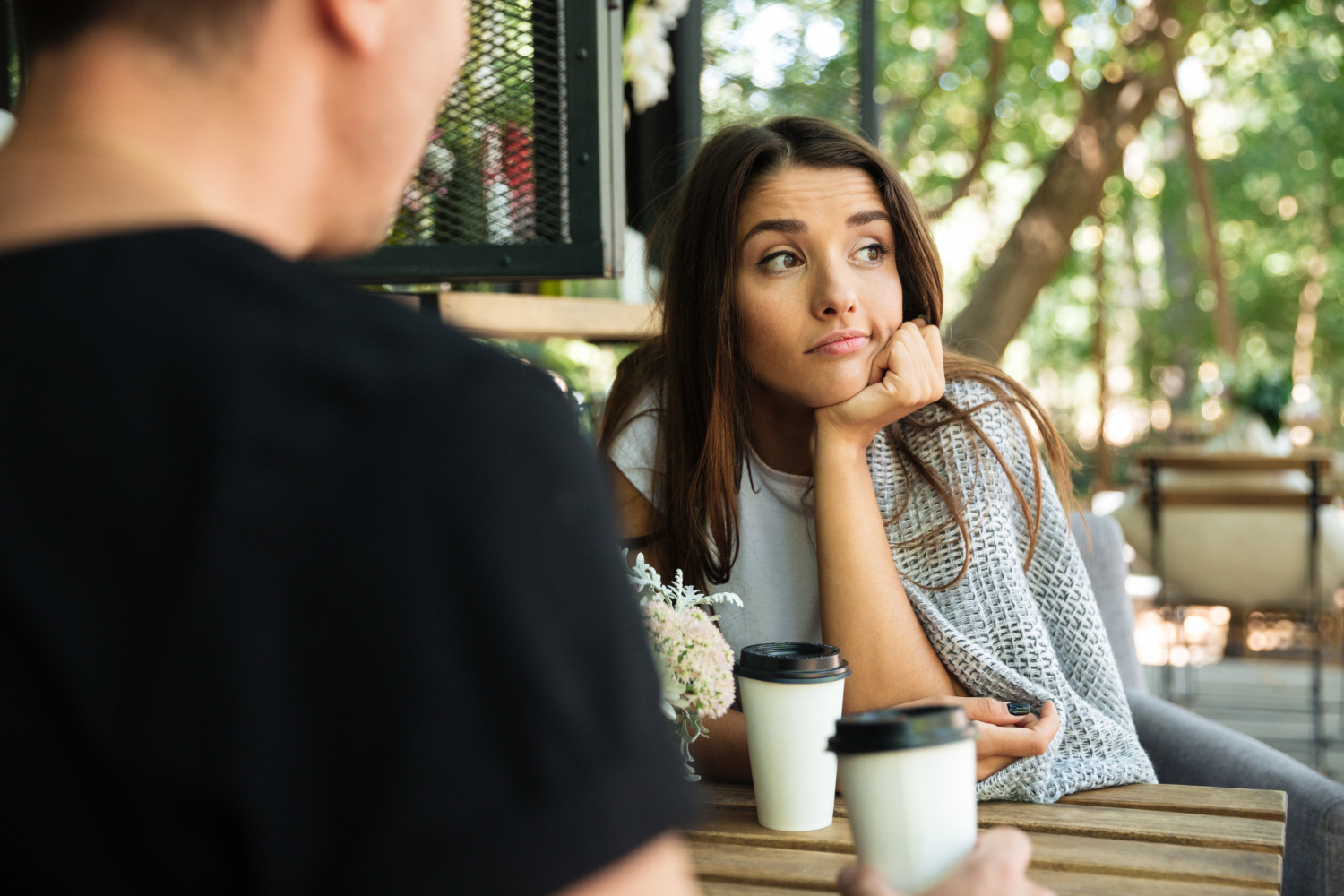 tired bored woman sitting drinking coffee