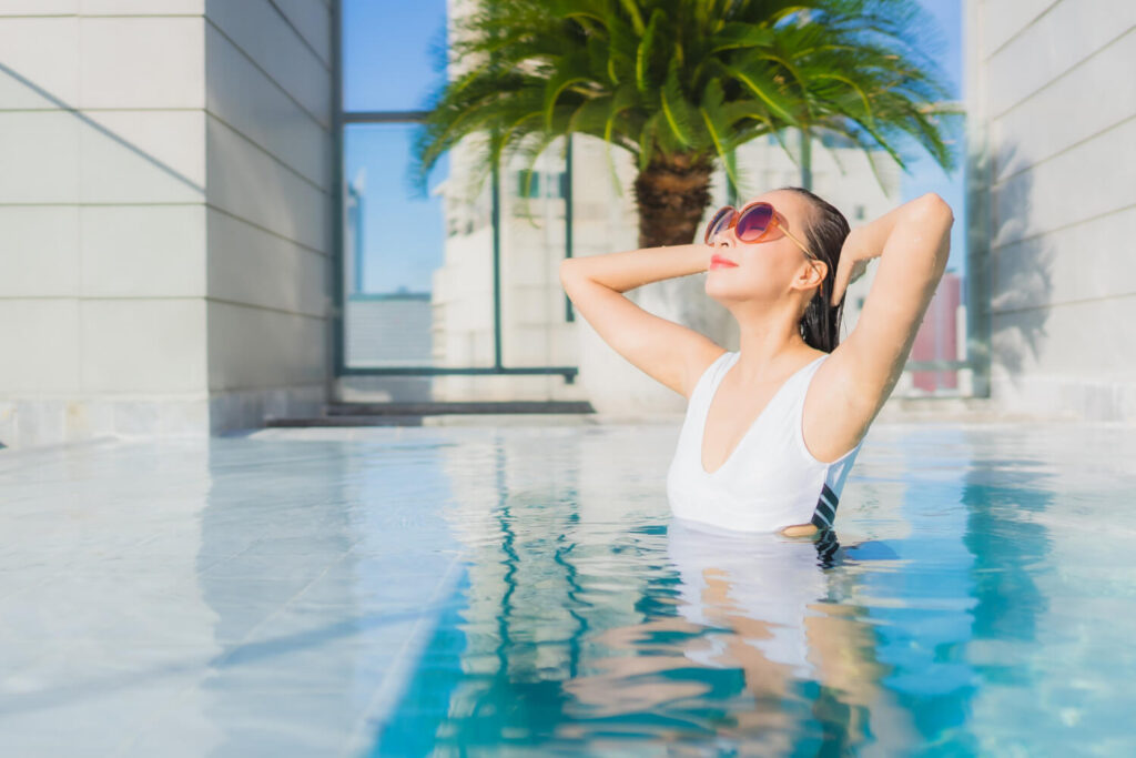 portrait beautiful young asian woman relaxes leisure around swimming pool