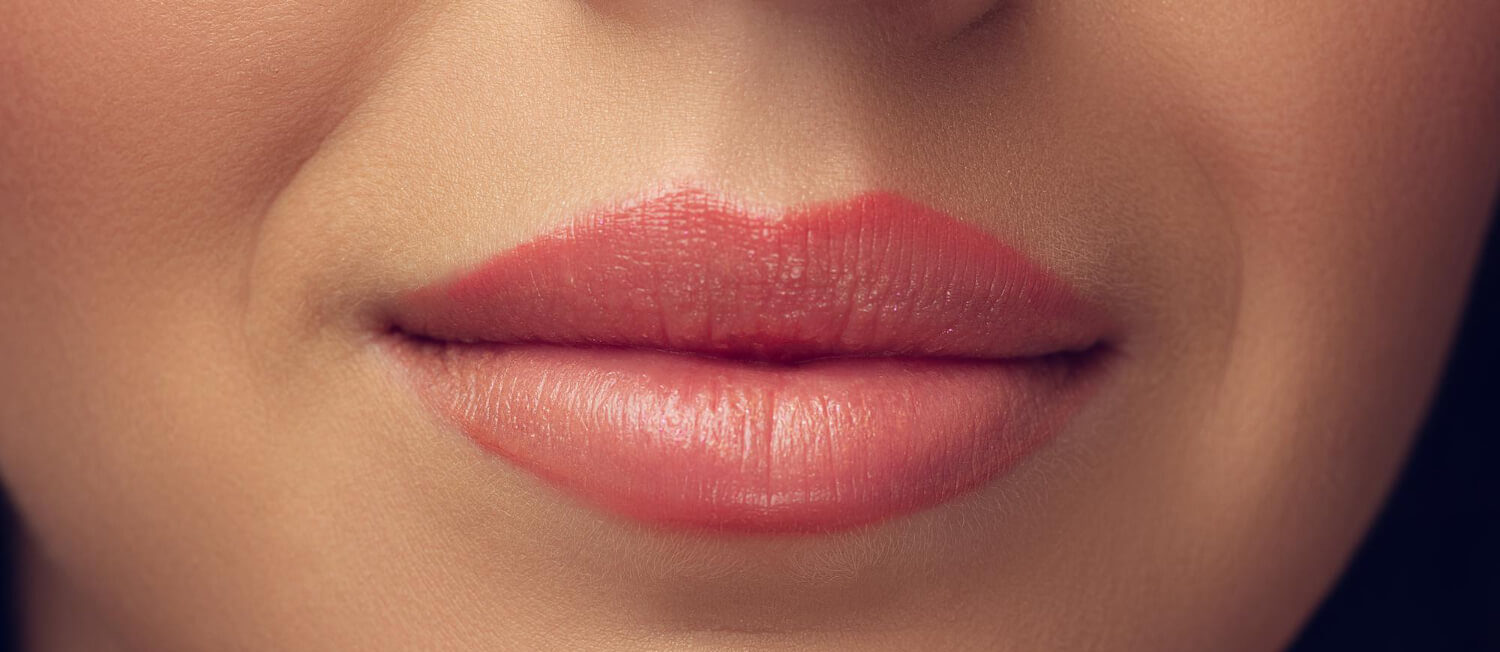 close up beautiful female face lips with bright stylish make up isolated grey