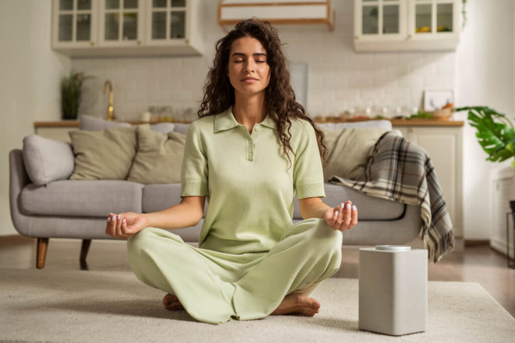 full shot woman meditating home