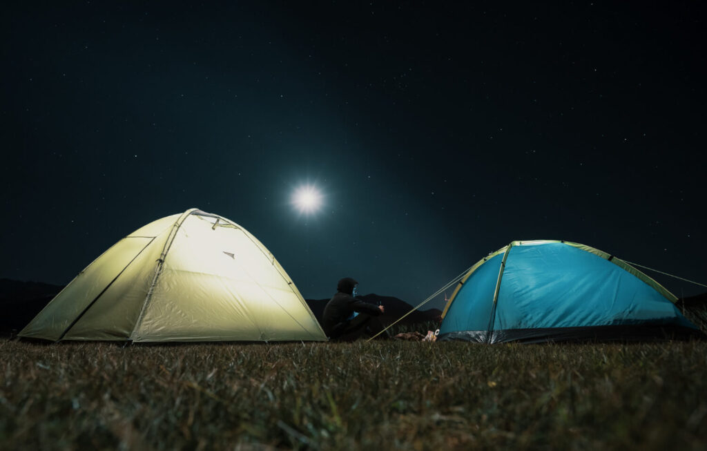 tourist tents camp meadow night mountains