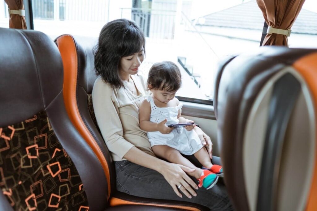 a woman with baby child in a bus