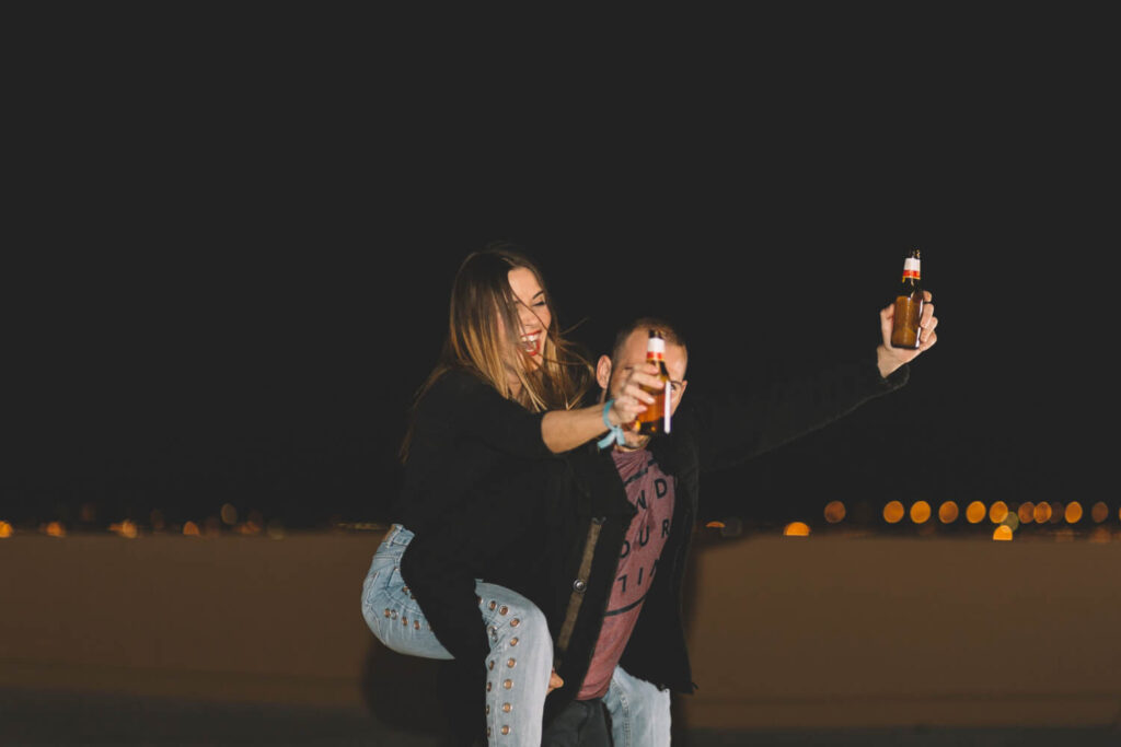 couple with beer having fun roof: unique and best cheap date ideas