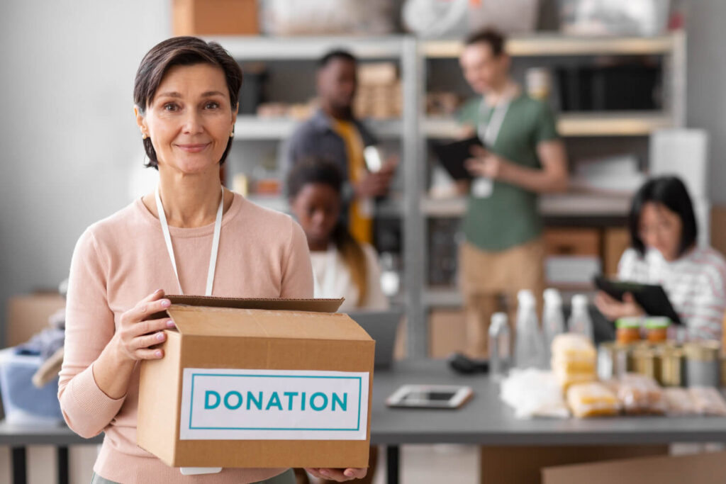 volunteer helping with donation box