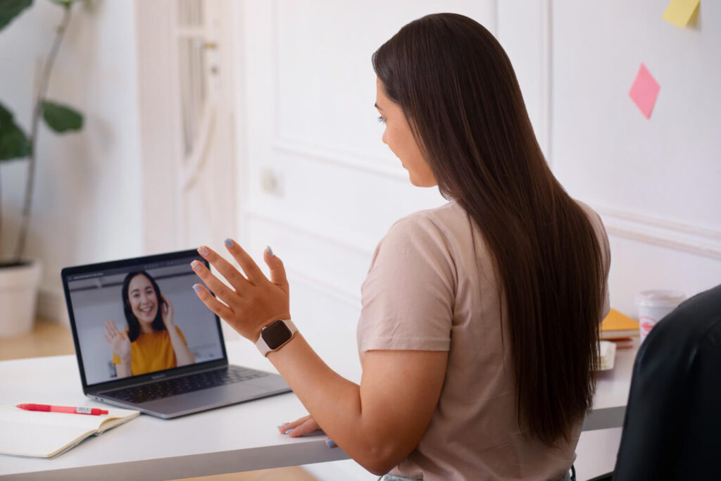 woman having videocall using laptop device from home: interview outfits for women