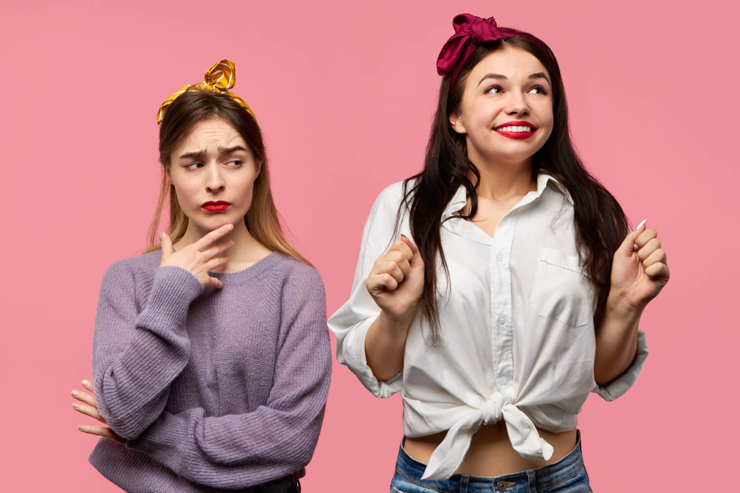 portrait attractive young woman with black hair red lips looking up with eyes full excitement clenching fists her distrustful suspicious female friend having doubtful look touching finger: never have I ever questions