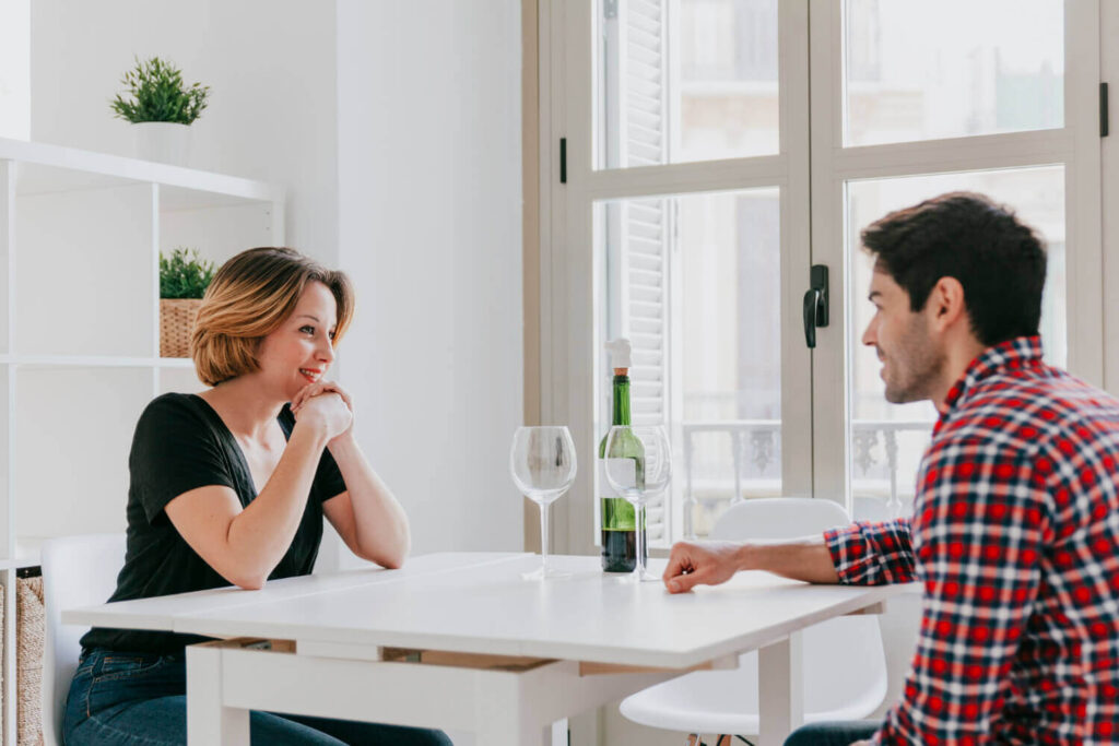 couple drinking wine talking table