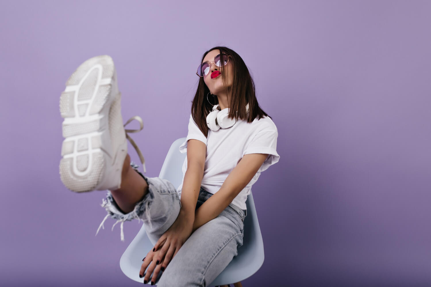 confident european lady white sneakers sitting chair making faces portrait wonderful girl posing